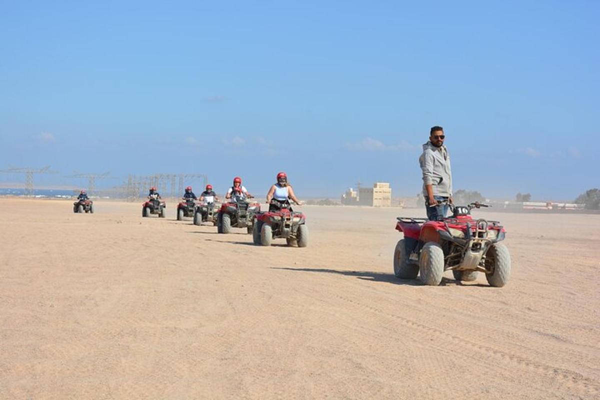 a group of people riding atvs in the desert
