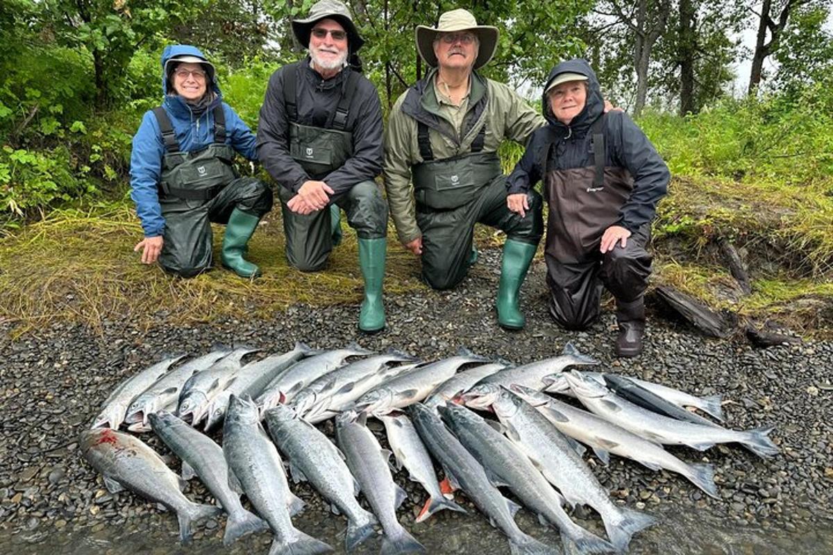 a group of people standing next to a group of fish