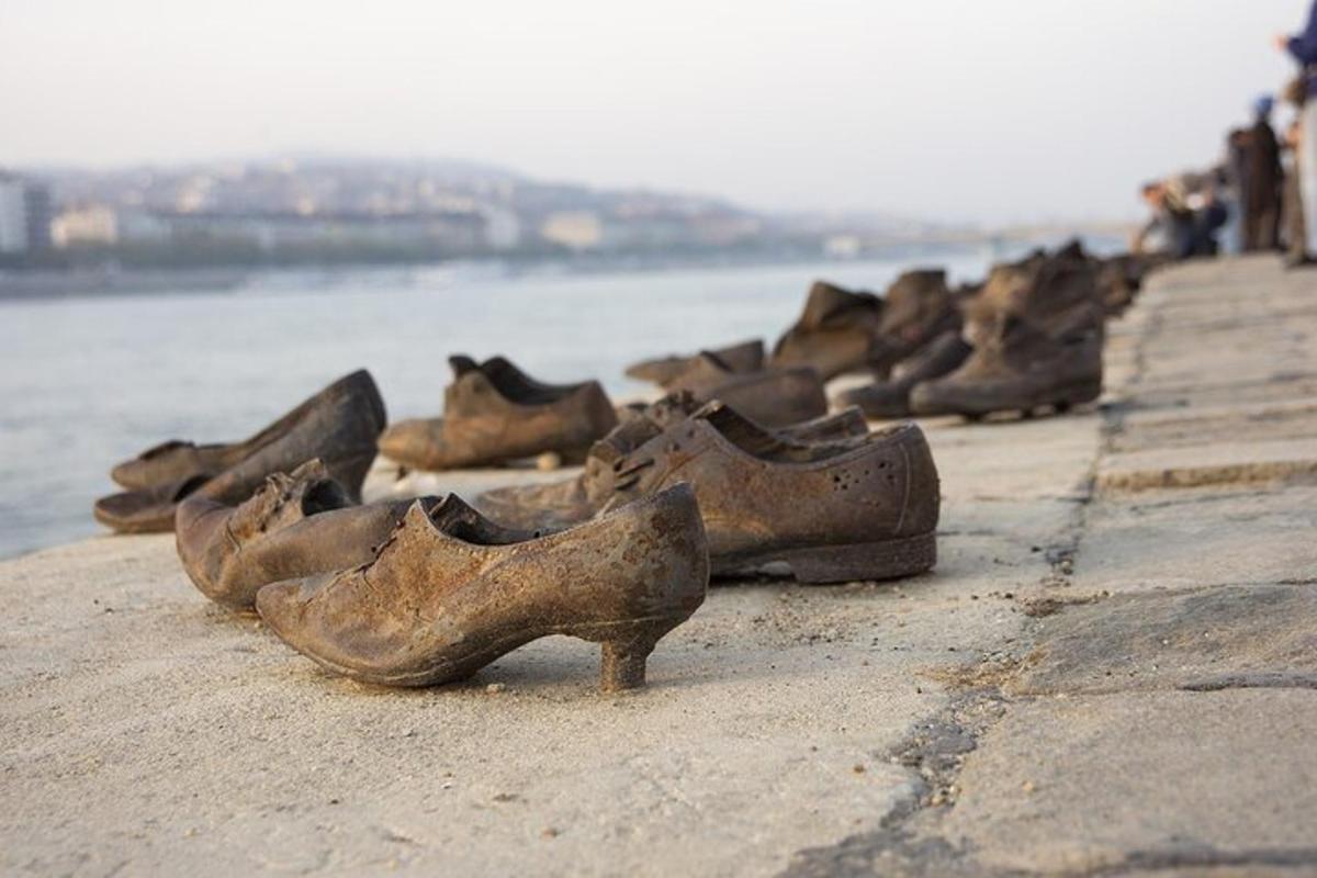 a group of shoes sitting on a sidewalk near the water