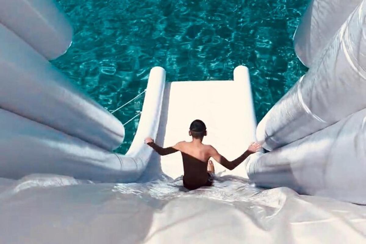 a man is in the water on a water slide