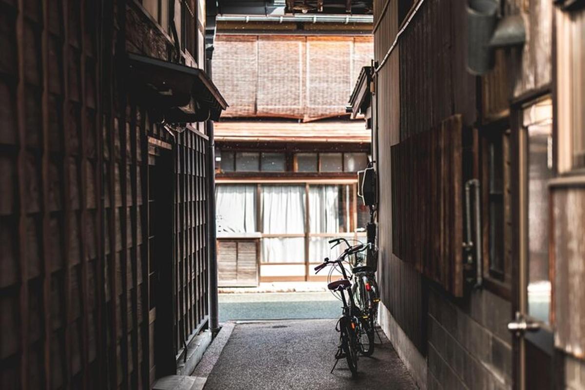 an alley with two bikes parked next to a window