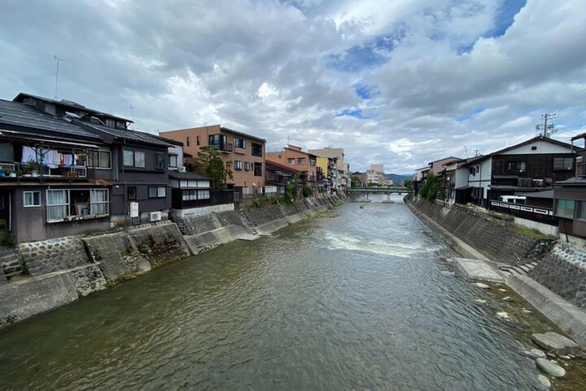 a river in a city with houses and buildings