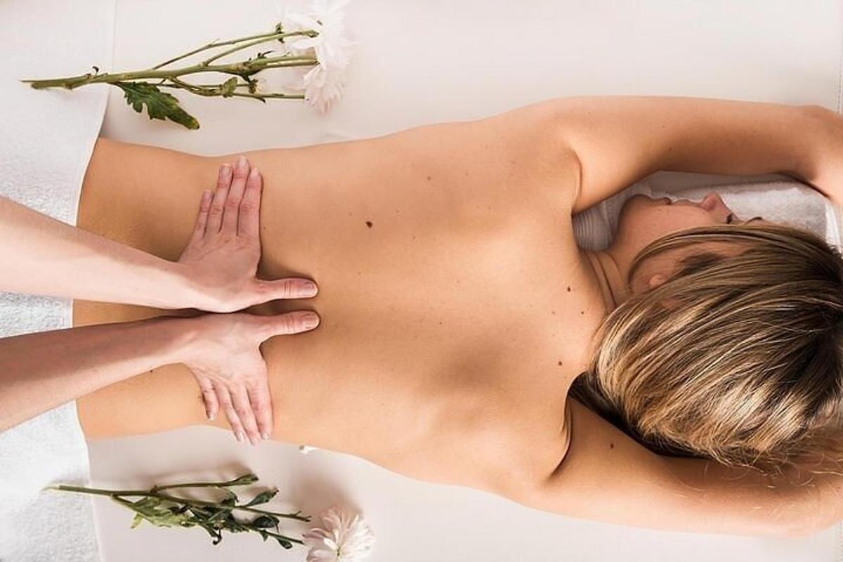 uma mulher deitada de costas em uma mesa de massagem