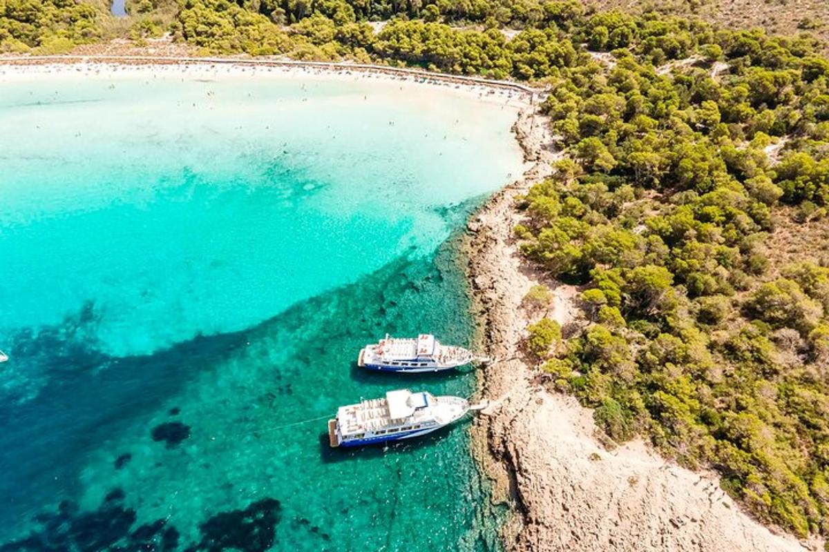 two boats sitting on the shore of a beach