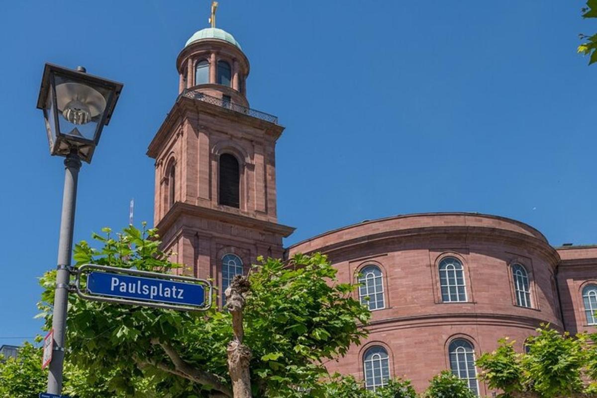 a street sign in front of a building with a tower