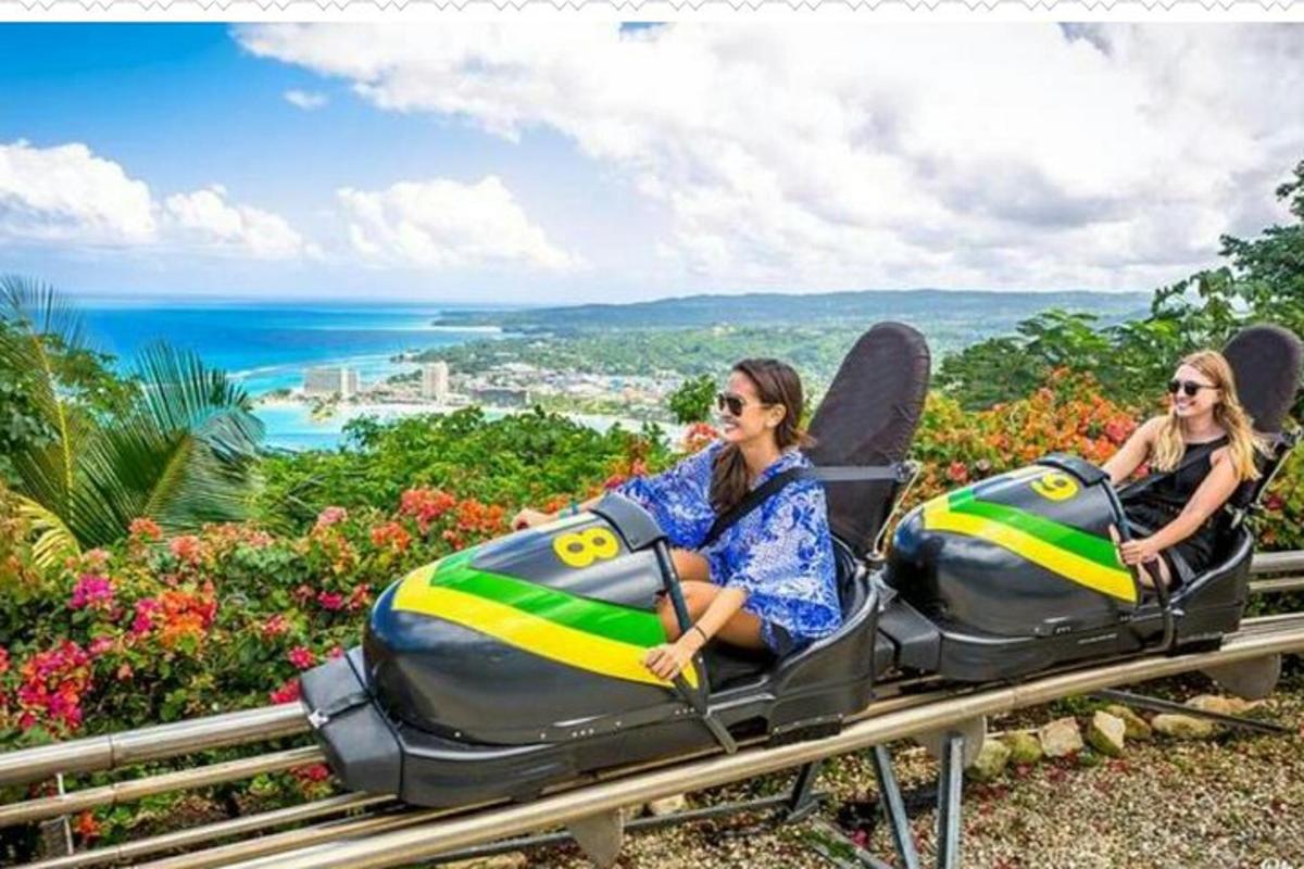 dua wanita menaiki roller coaster taman hiburan