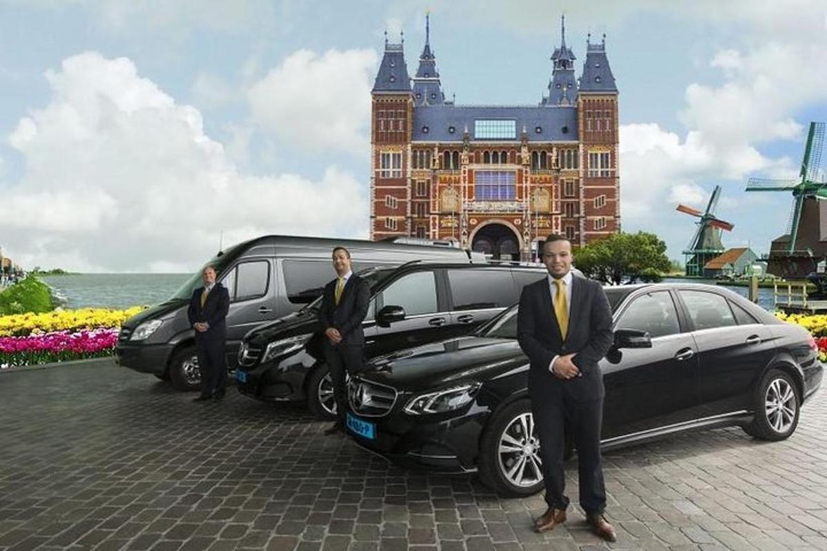 a group of three men in suits standing next to a car