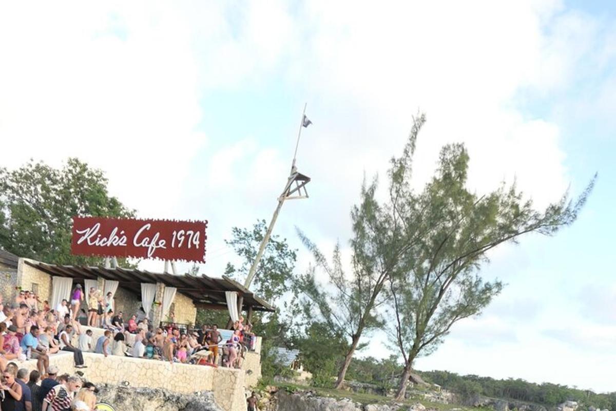 a crowd of people sitting on top of a building