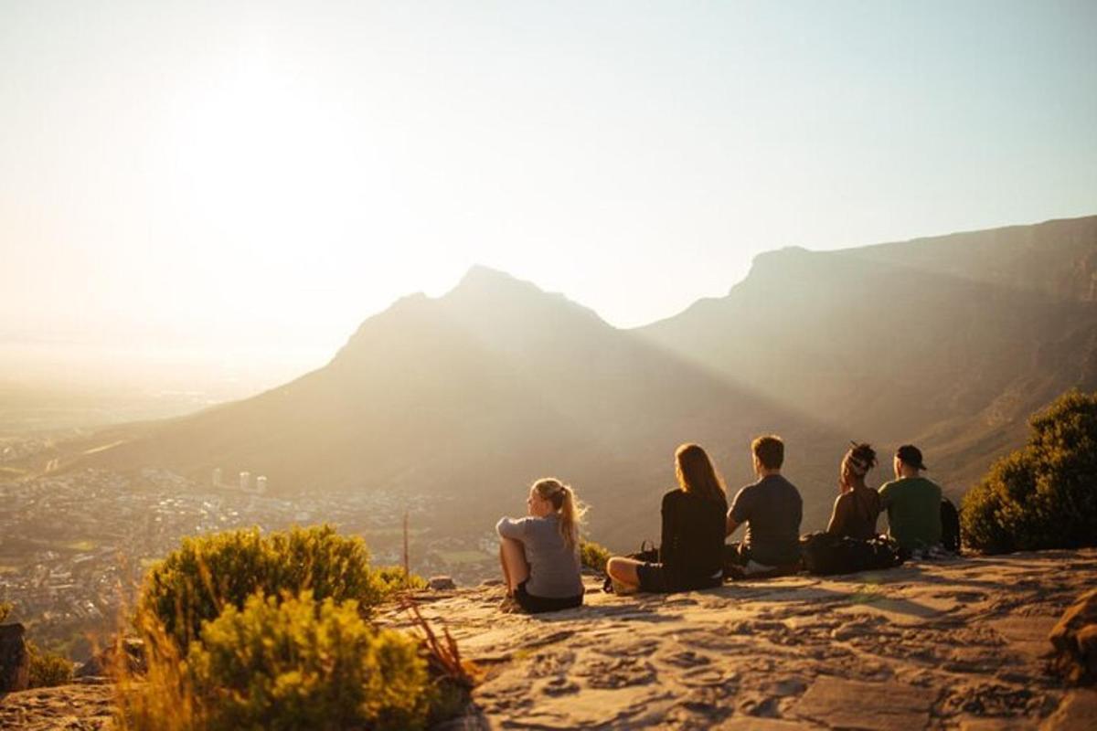 a group of people sitting on top of a mountain