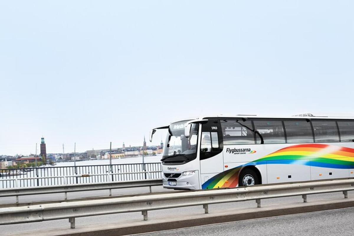 a bus with a rainbow on a highway