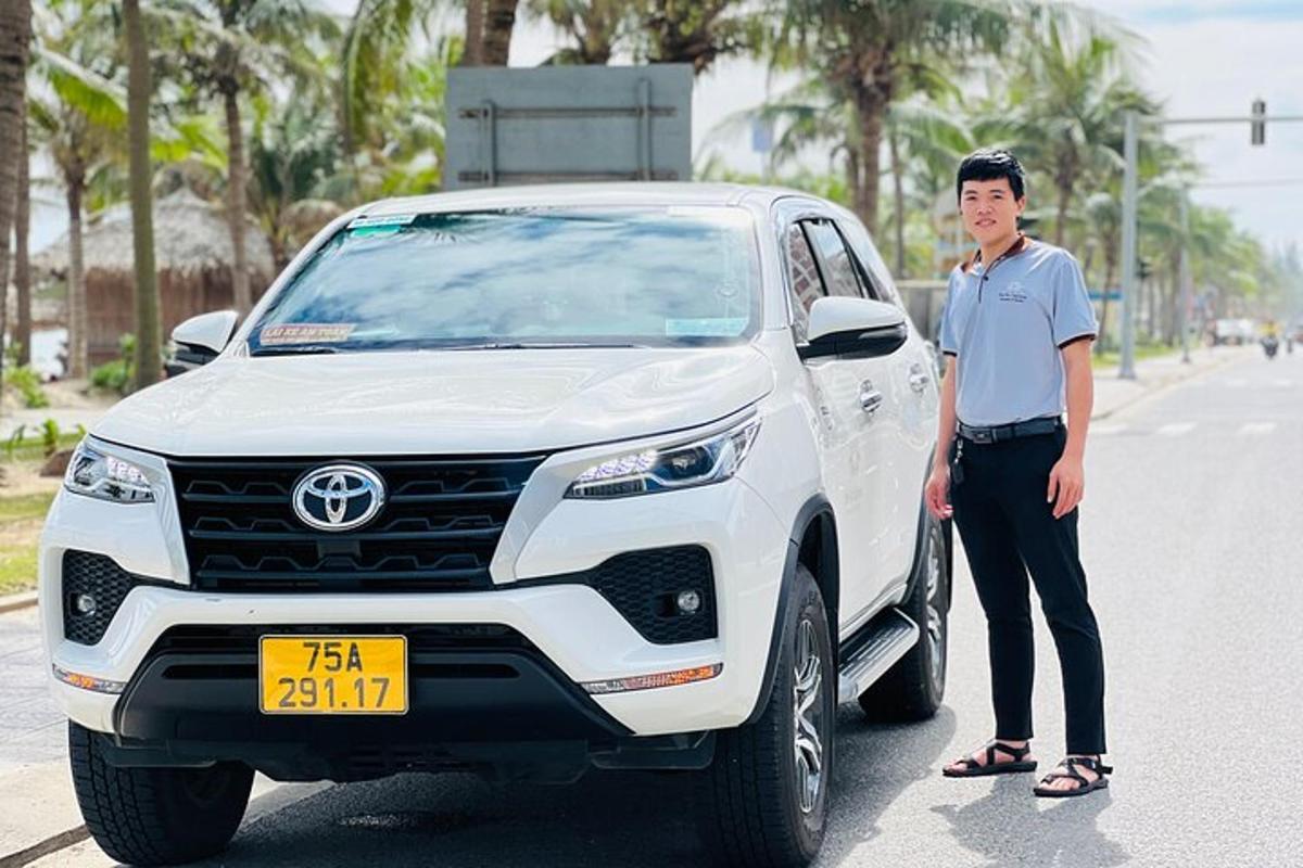 a man is standing next to a white car
