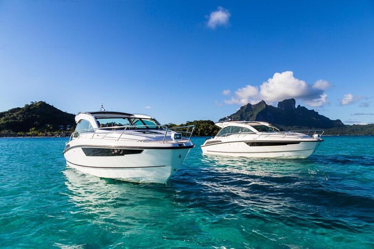 two boats sitting in the water in the ocean