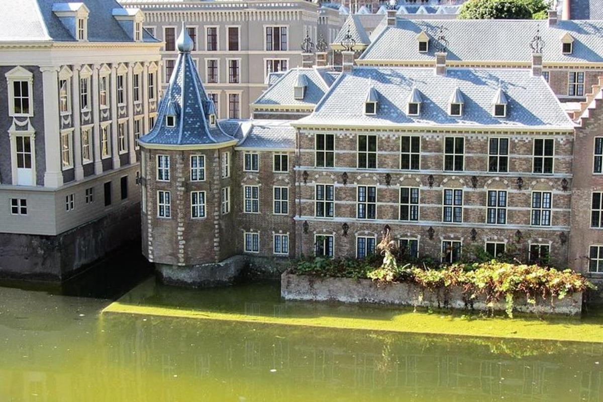 a large building in the water next to some buildings
