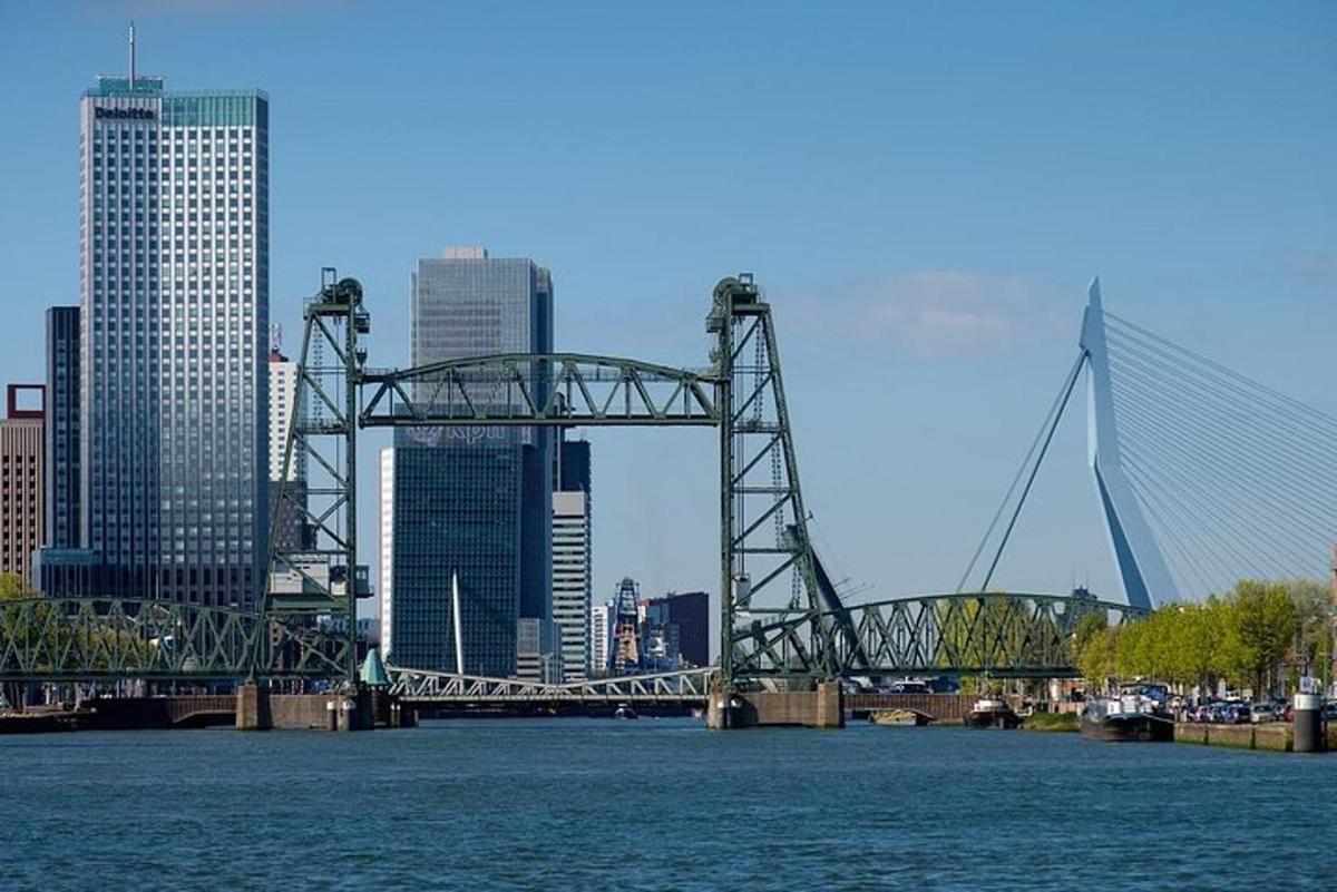 a bridge over the water with a city in the background