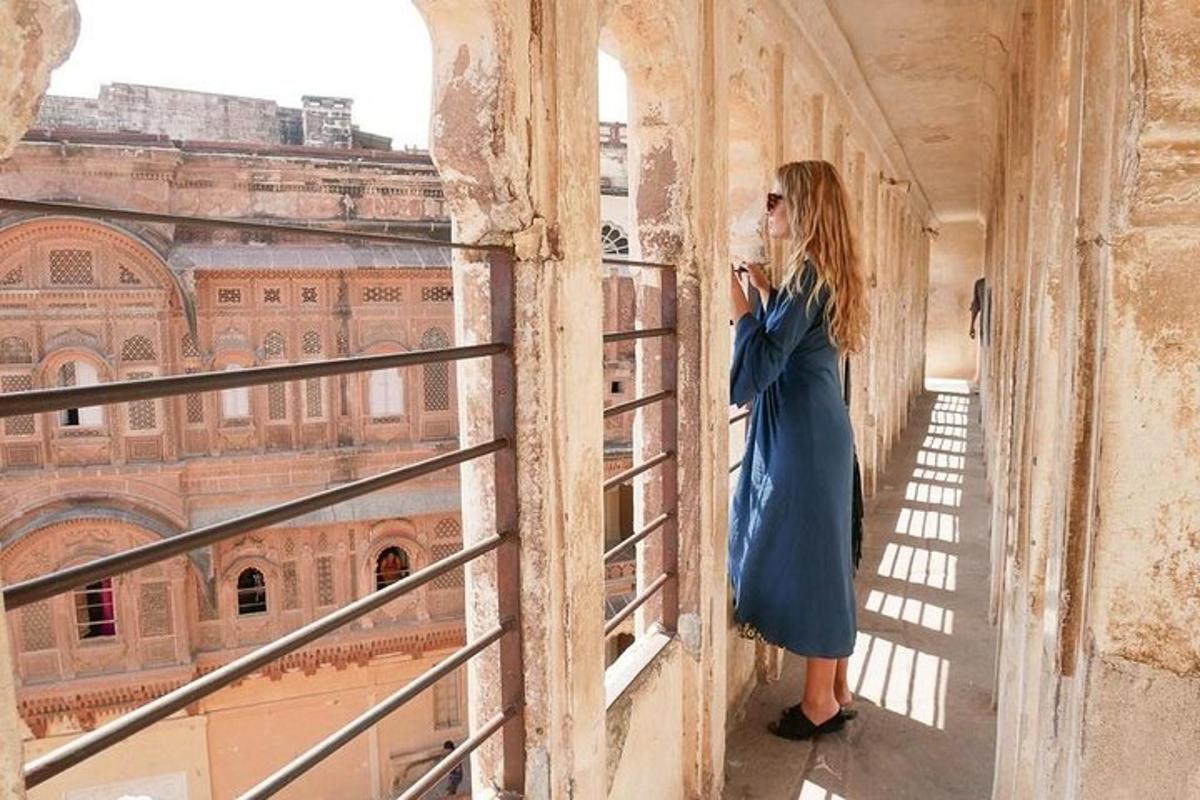 a woman looking out of a window at a building