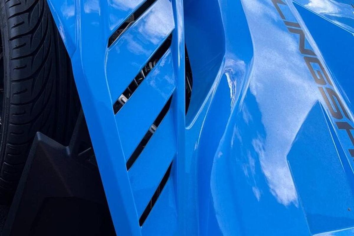 a close up of the side of a blue car