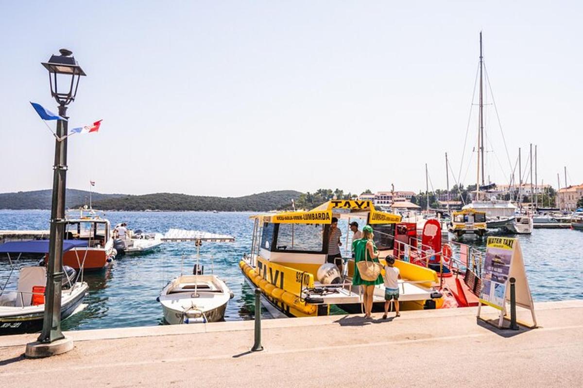 a yellow boat is docked at a dock with other boats