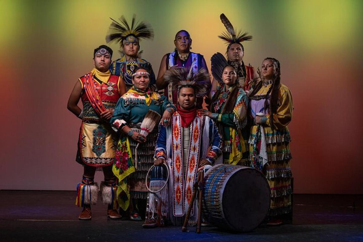 a group of people dressed in traditional clothing posing for a picture