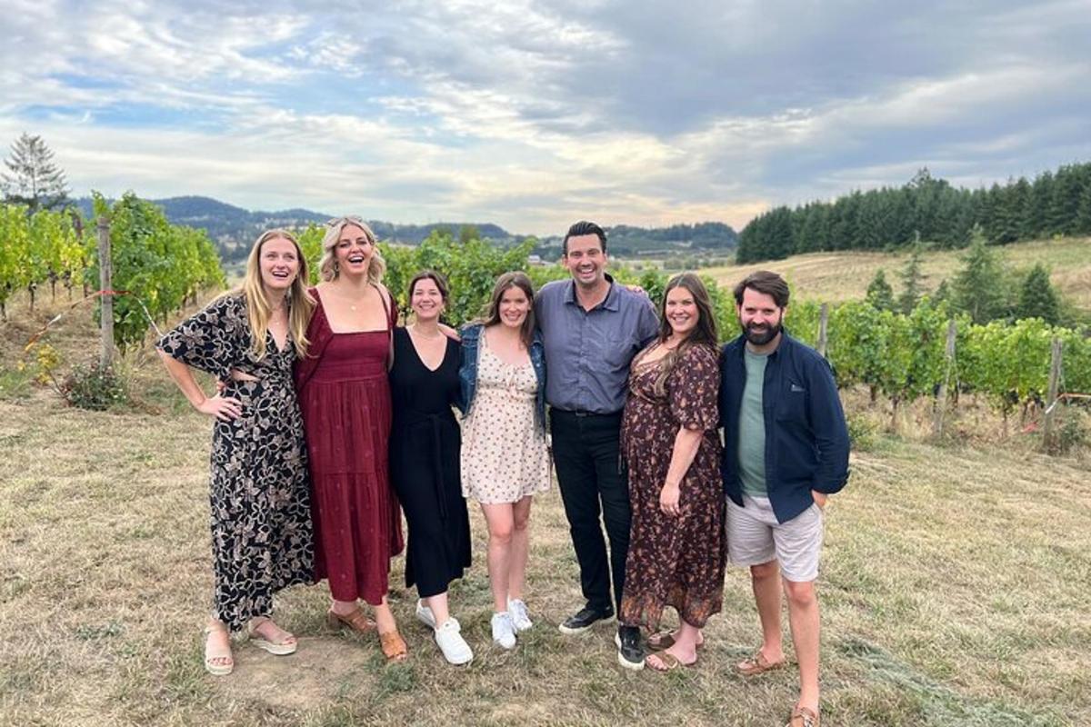 a group of people posing for a picture in a field
