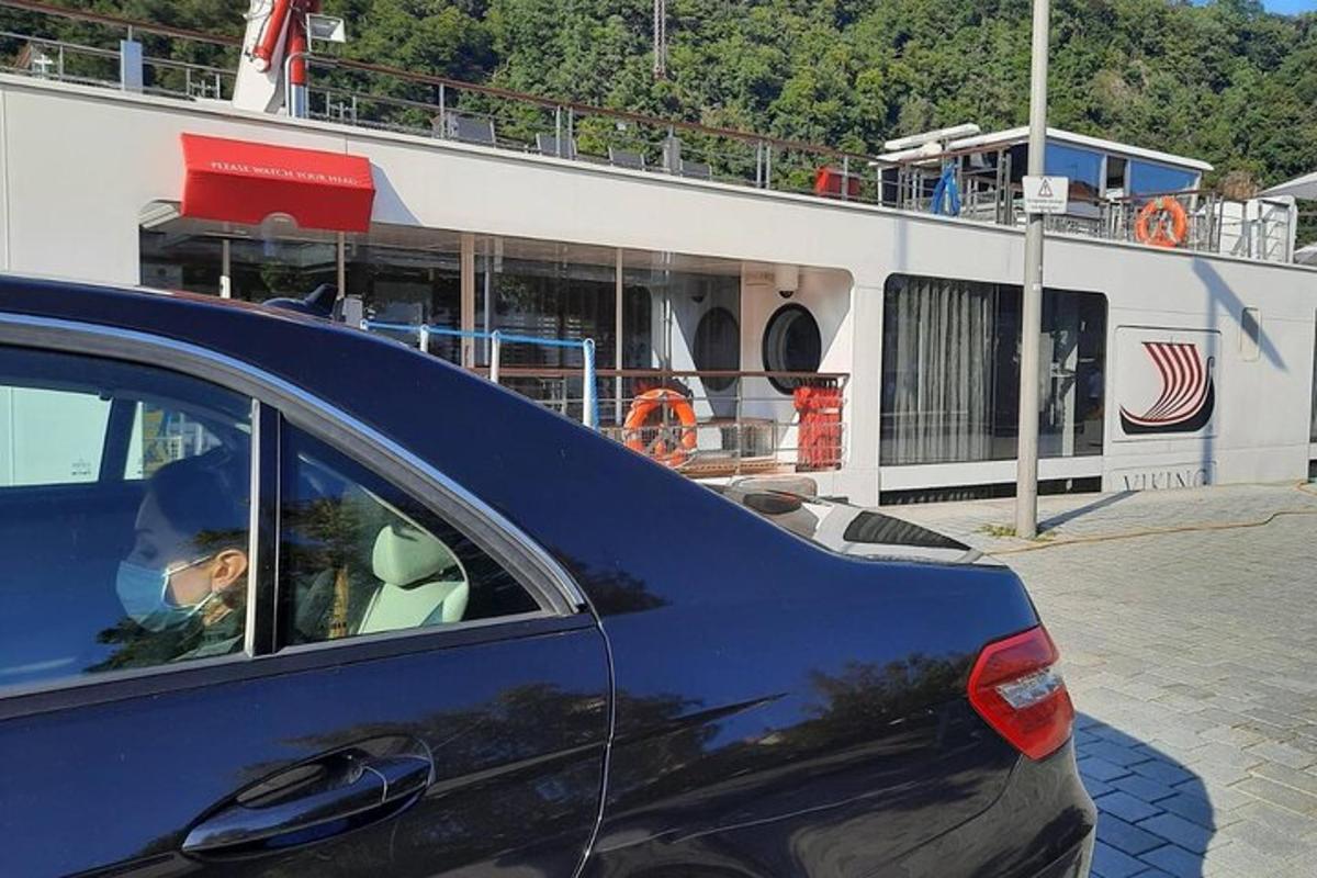 Un niño sentado en un coche delante de un crucero.