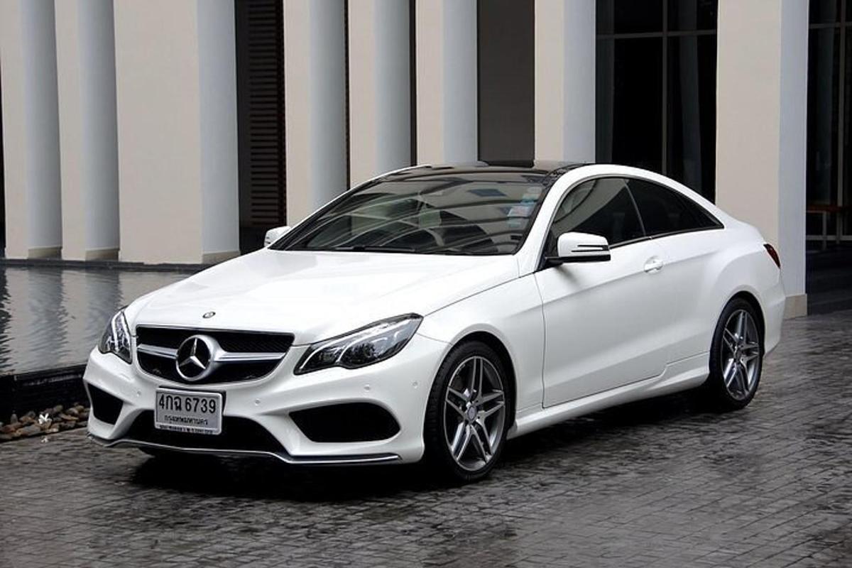 a white car parked in front of a building