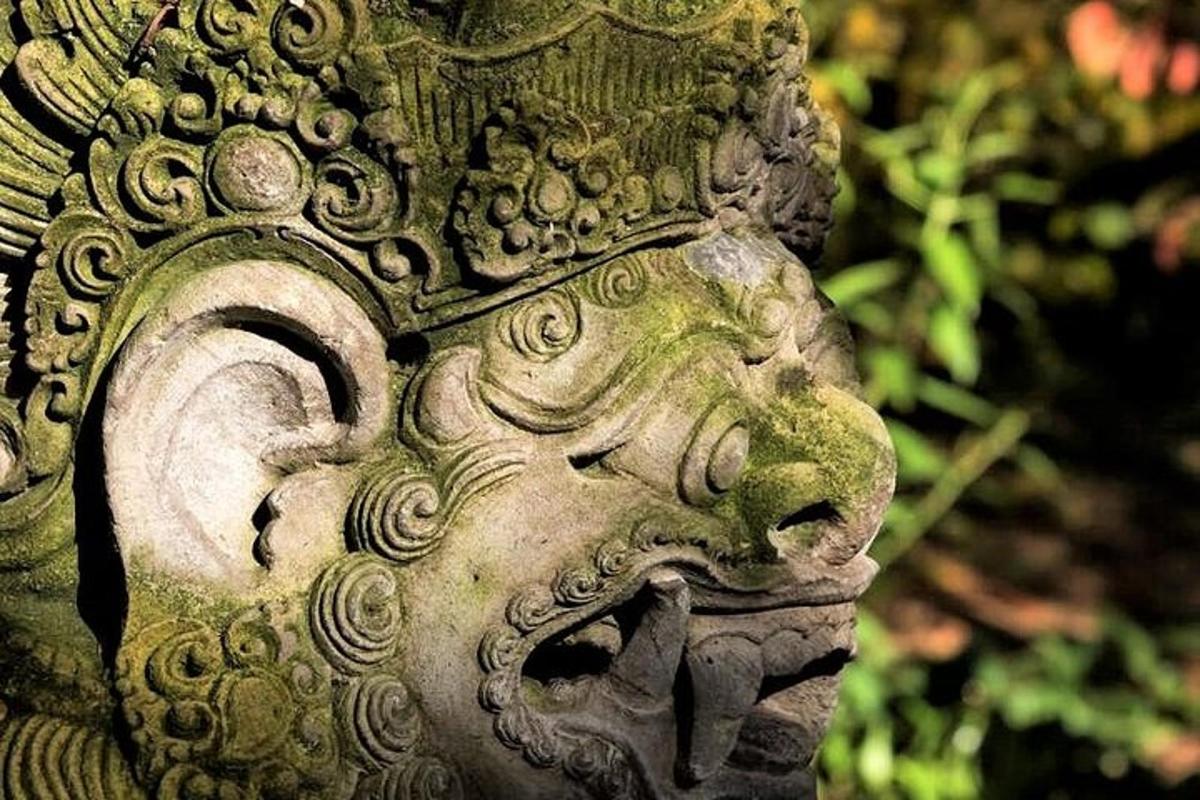 a stone statue of a face with its mouth