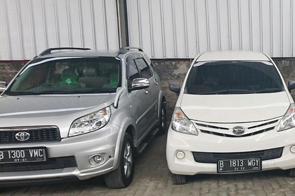 two white cars parked next to each other