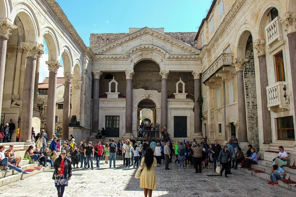 um grupo de pessoas em pé em frente a um grande edifício