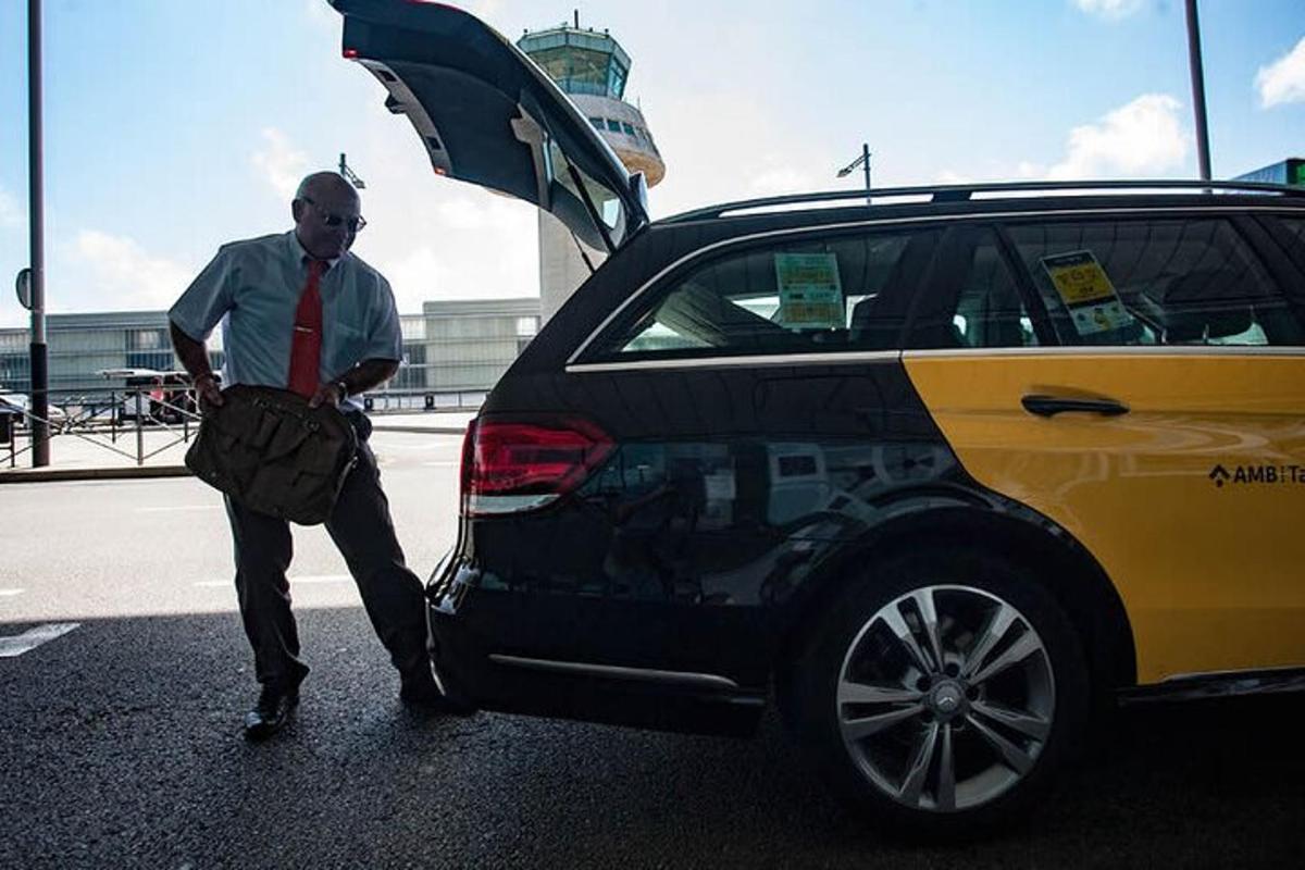 a man standing next to a car with its door open