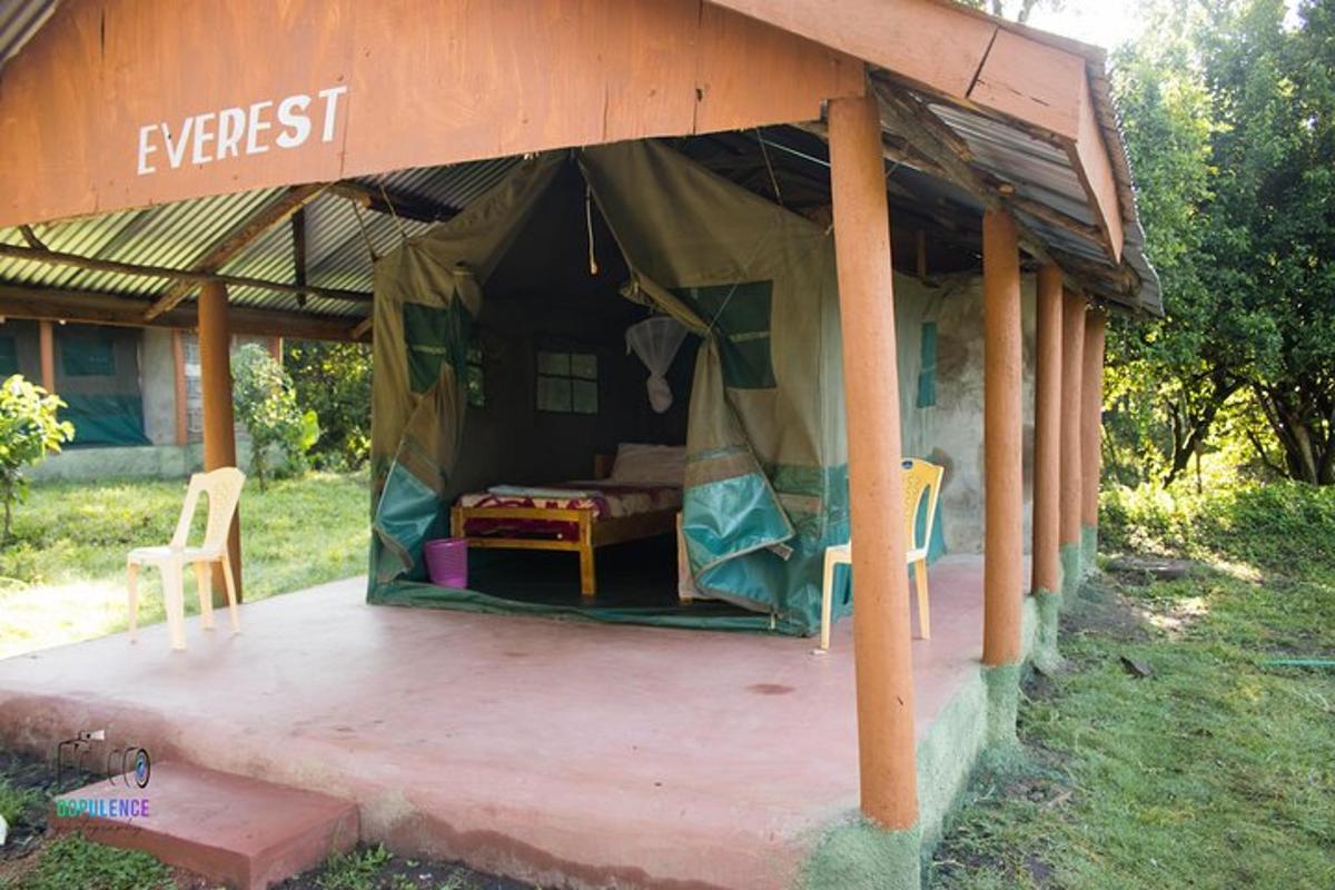 a tent with two chairs and a table in it