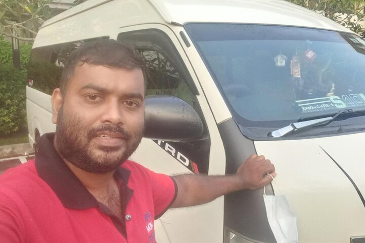 a man standing in front of a white van