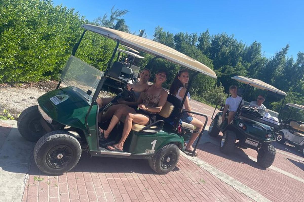 a group of people riding in a golf cart