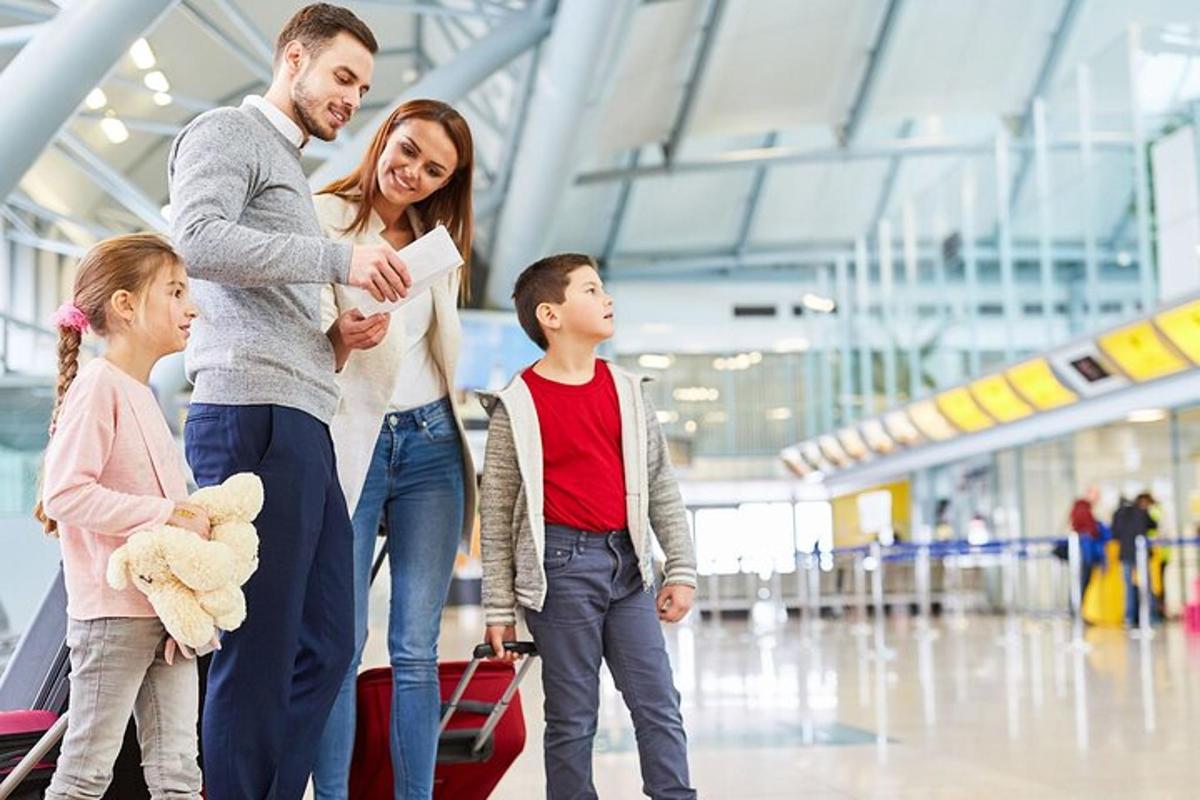 a family walking through an airport with luggage