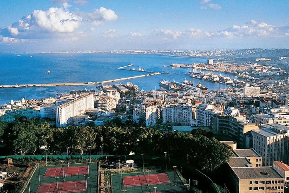 an aerial view of a city with the ocean