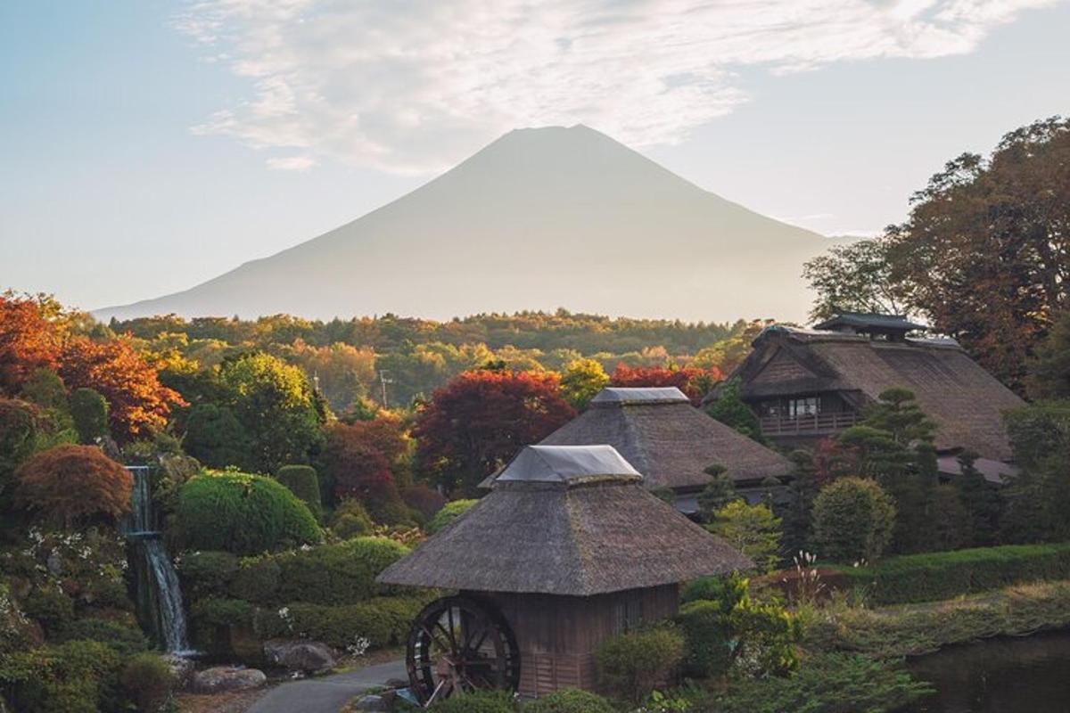 a view of a mountain with a house and a wheel