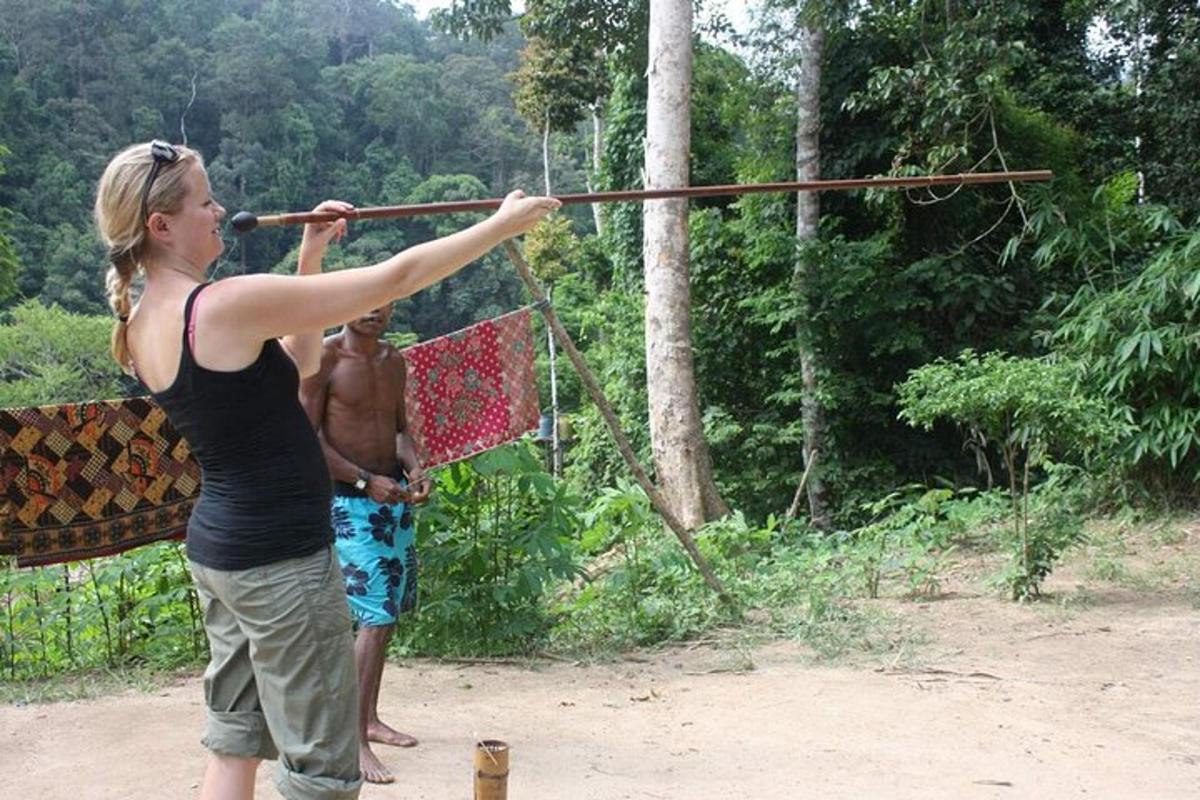 a woman playing with a bow and arrow with a man