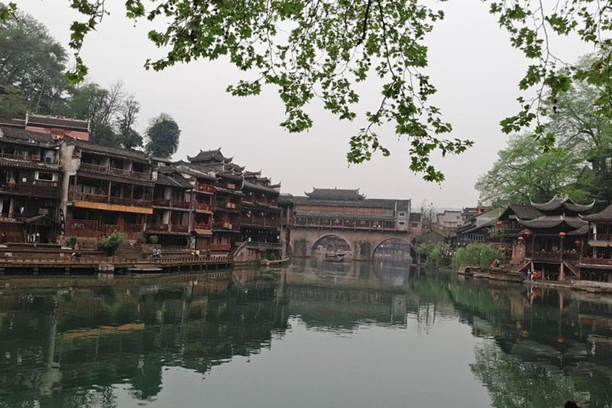 a bridge over a river with many buildings and a bridge