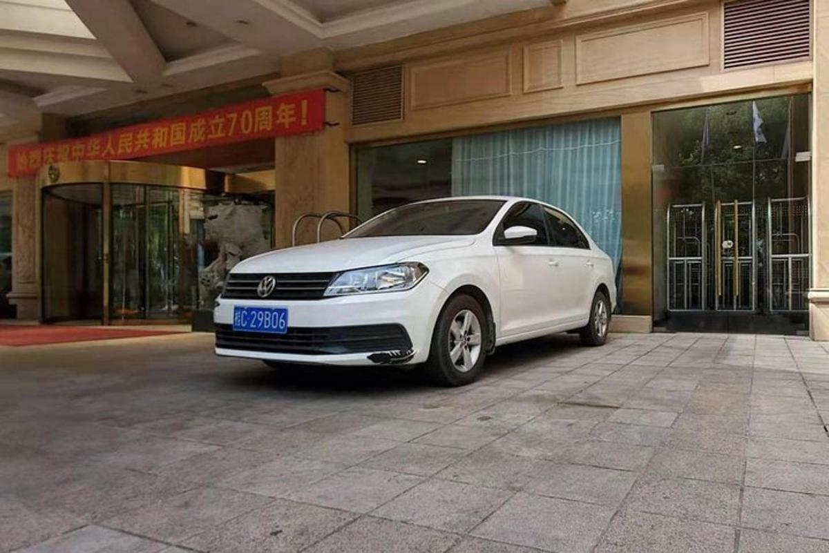 a white car parked in front of a building