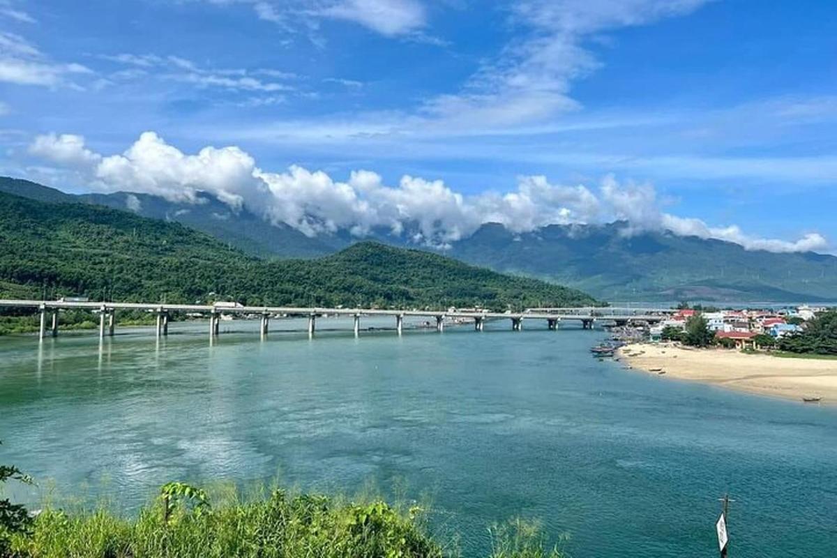 a bridge over a river next to a beach