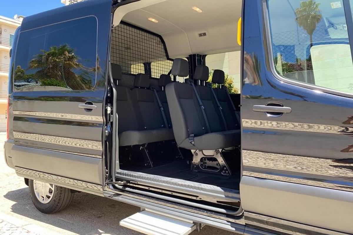 an open door of a blue rv with the back seats