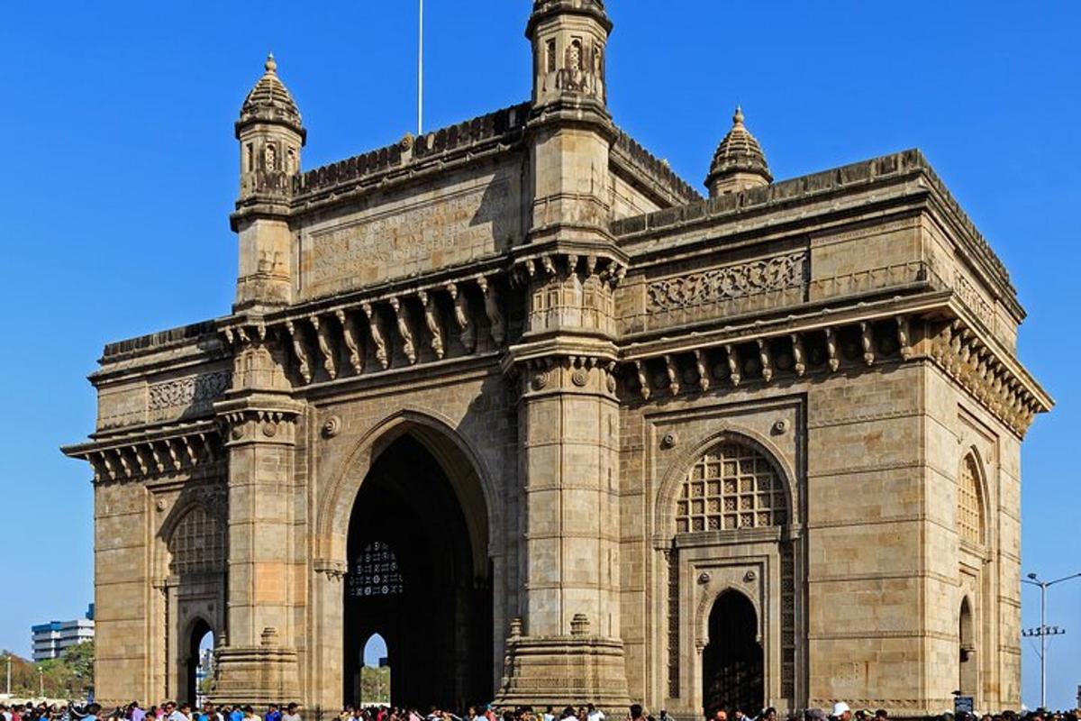a large stone building with a crowd of people in front
