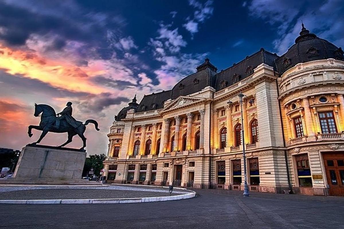 a statue of a man on a horse in front of a building