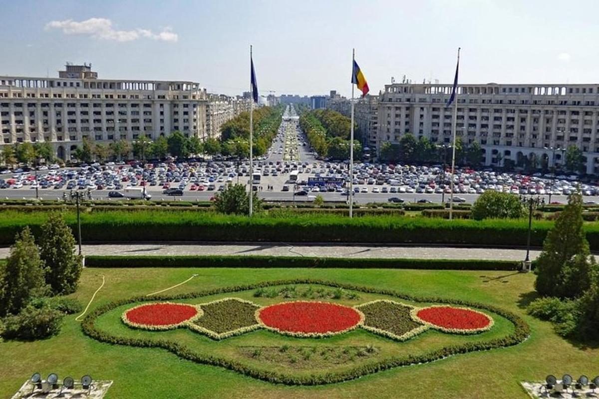a flower garden in front of a large building