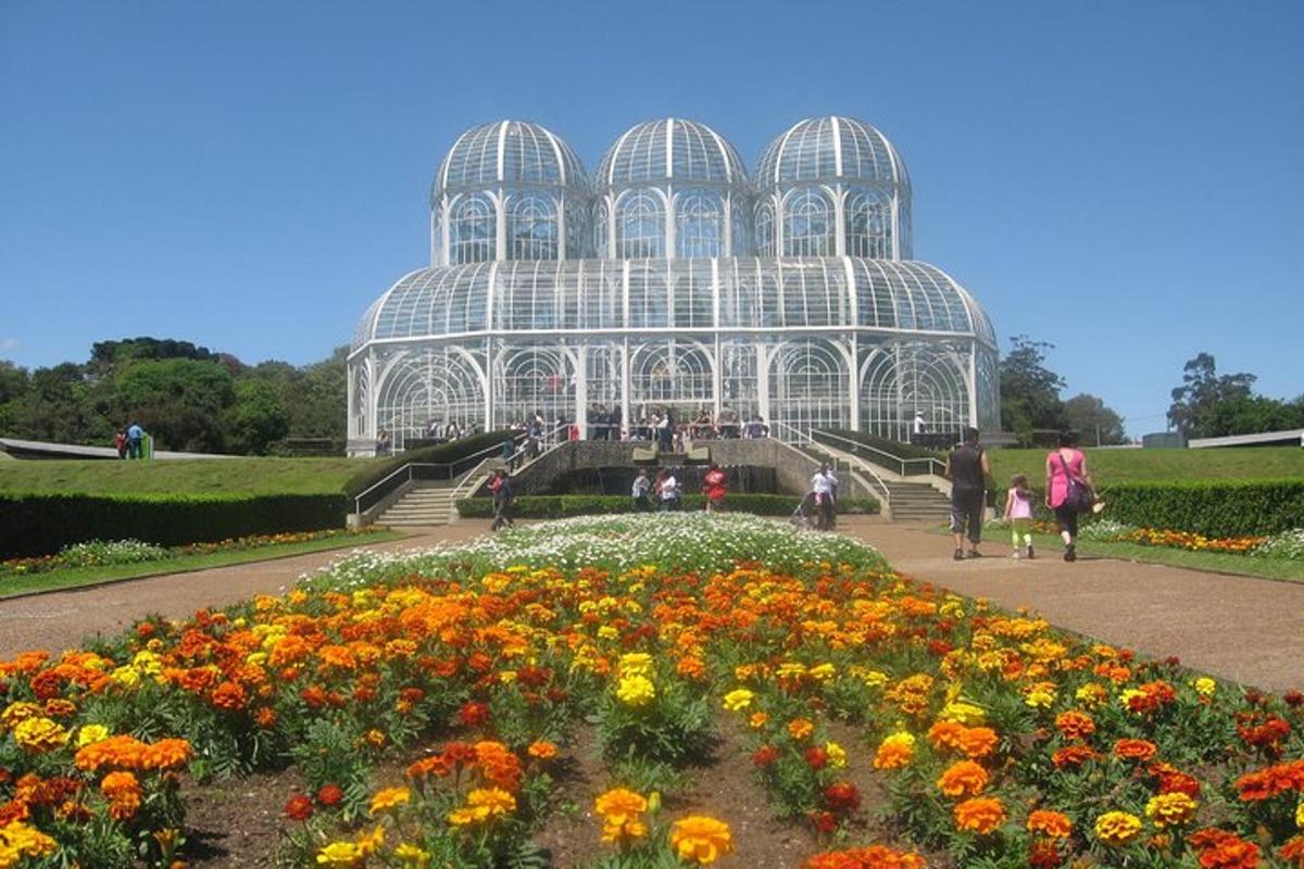 a greenhouse with a bunch of flowers in front of it