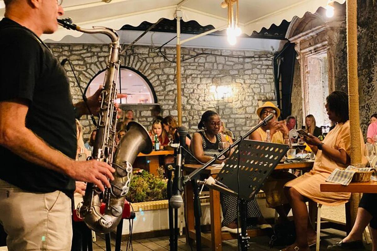 a man playing instruments in front of a group of people