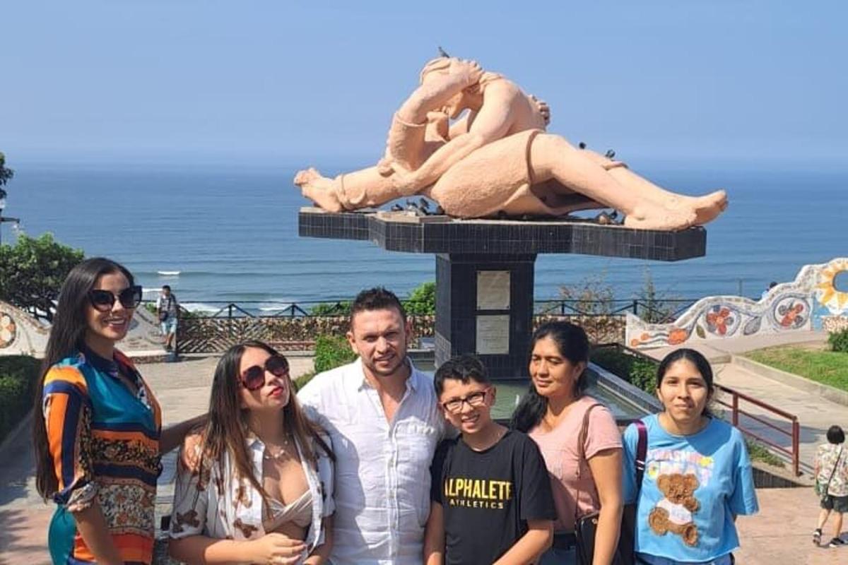 a group of people standing in front of a statue