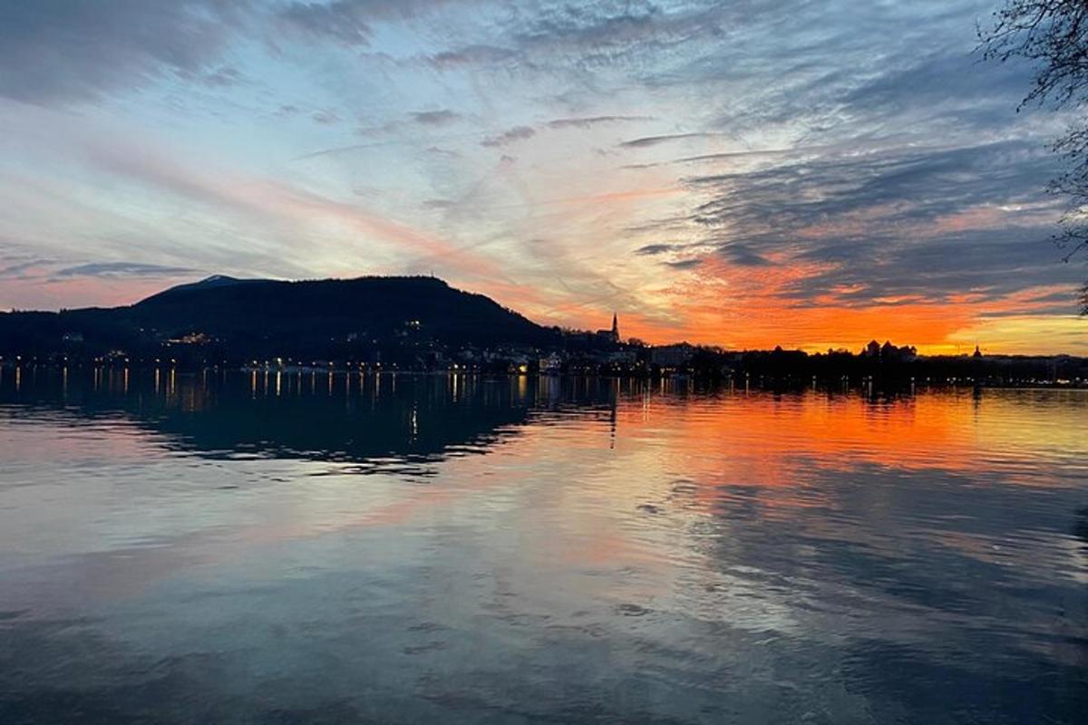 a body of water with a sunset in the background
