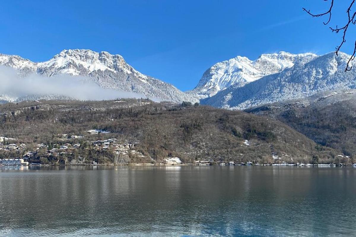 a view of a lake with snow covered mountains