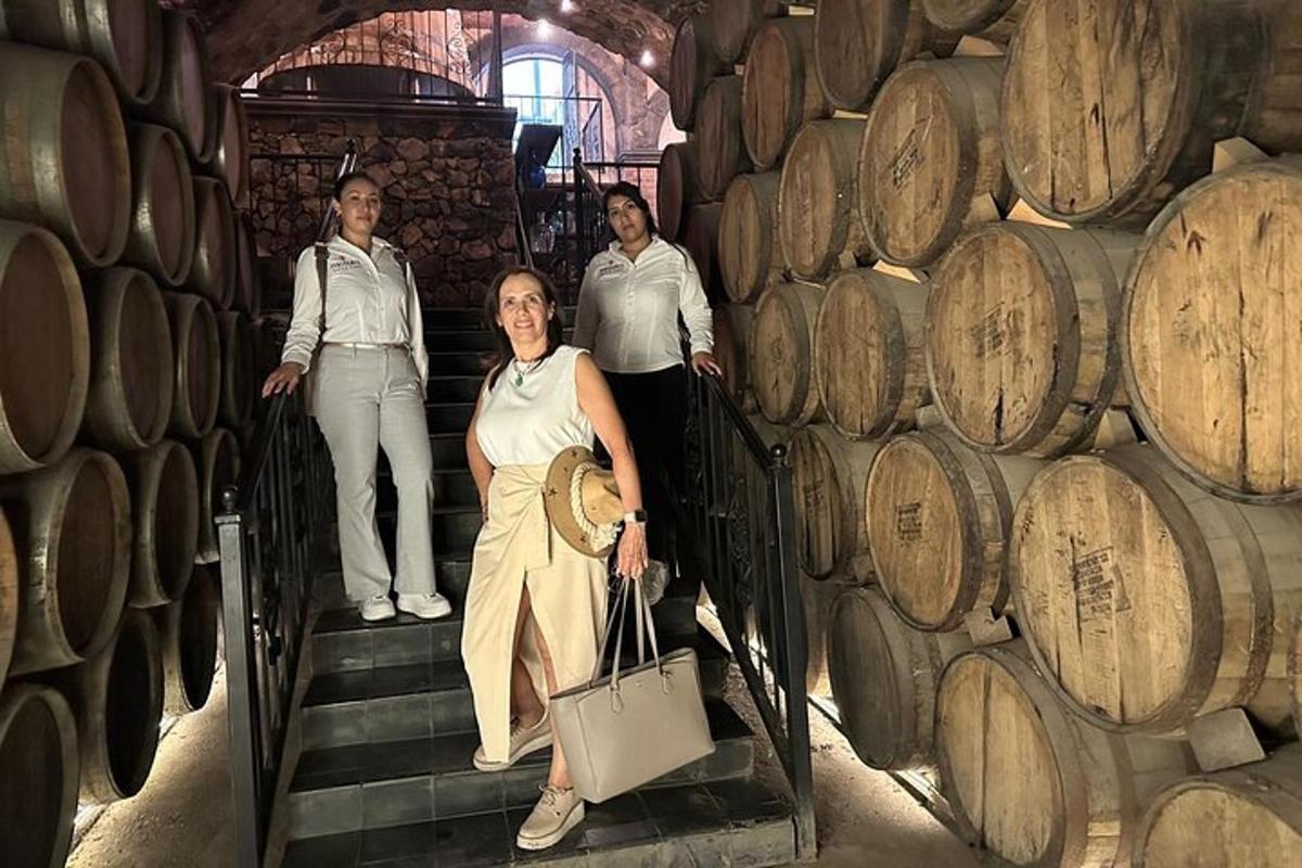 a woman standing on stairs in a wine cellar