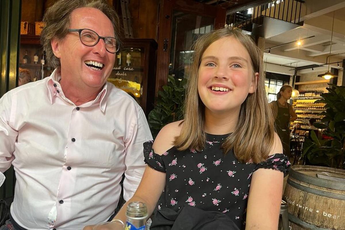a man and a little girl sitting next to each other